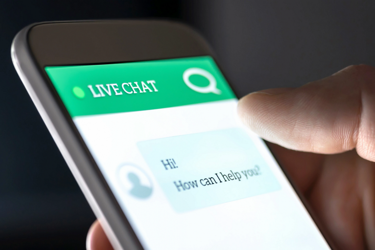 A smartphone screen showing a live chat with 'Hi! How can I help you?'