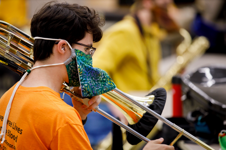 Trombone player wears special instrument mask