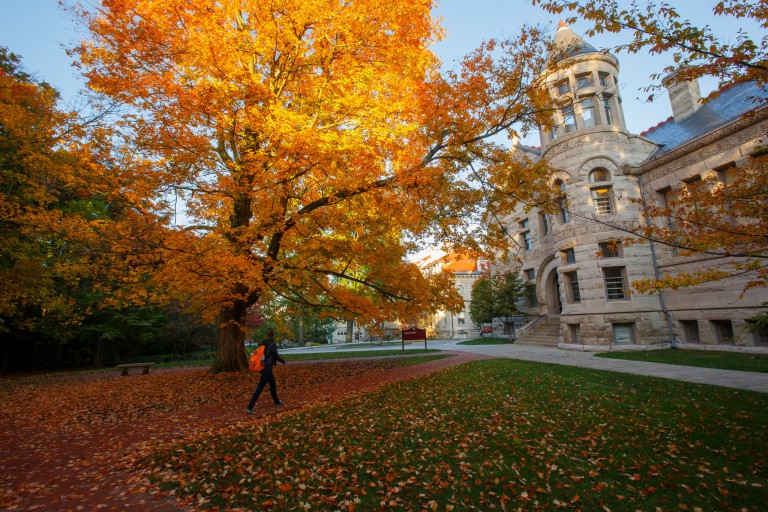 A student walks through IU's Old Crescent during fall