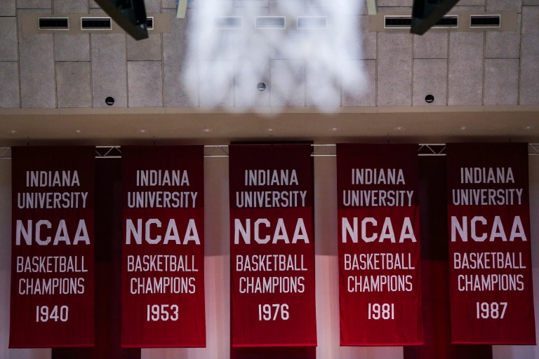 Five red-and-white basketball championship banners hang in Simon Skjodt Assembly Hall