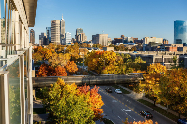 A view of downtown Indianapolis from IUPUI with colorful fall foliage of red, orange and yellow