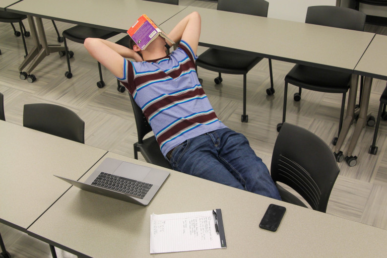 A student takes a break from studying by napping.