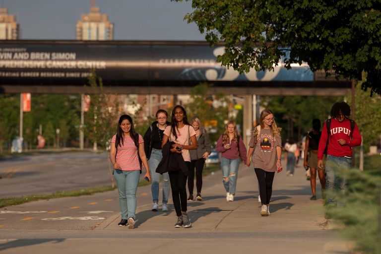 Students walking on a sidewalk on the IUPUI campus