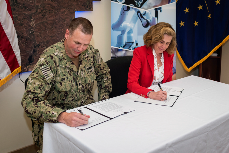 IU President Pamela Whitten and NSA Crane Commanding Officer Cmdr. James L. Smith sign an agreement