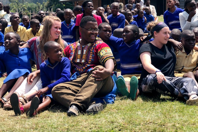 IU students sit with Rwandan students.