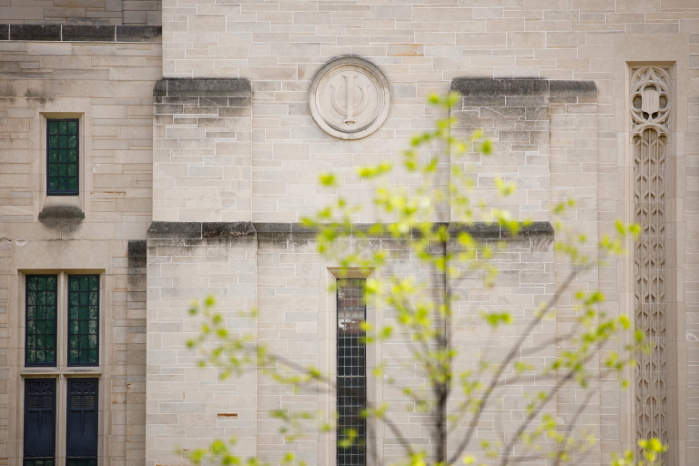 A limestone trident on a building on the IU Bloomington campus