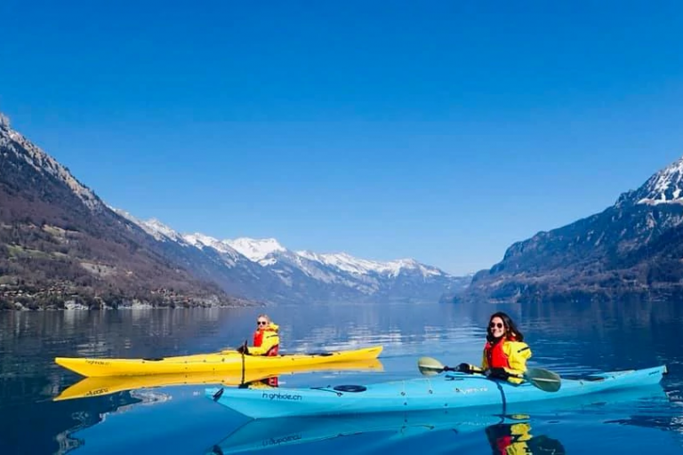 Two students in kayaks on a lake in Switzerland.
