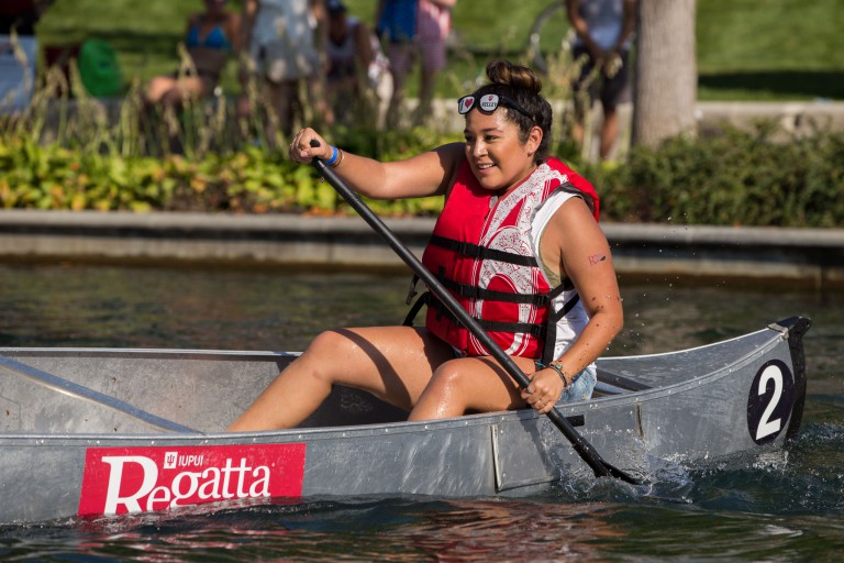 A student paddles in the Regatta.