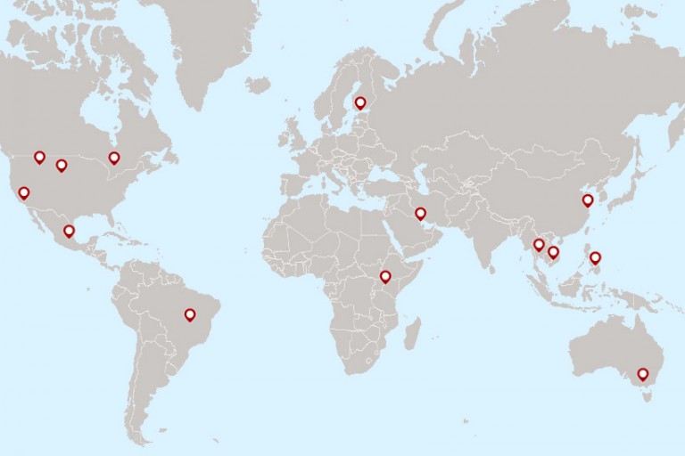 A map of the world with red pins on it