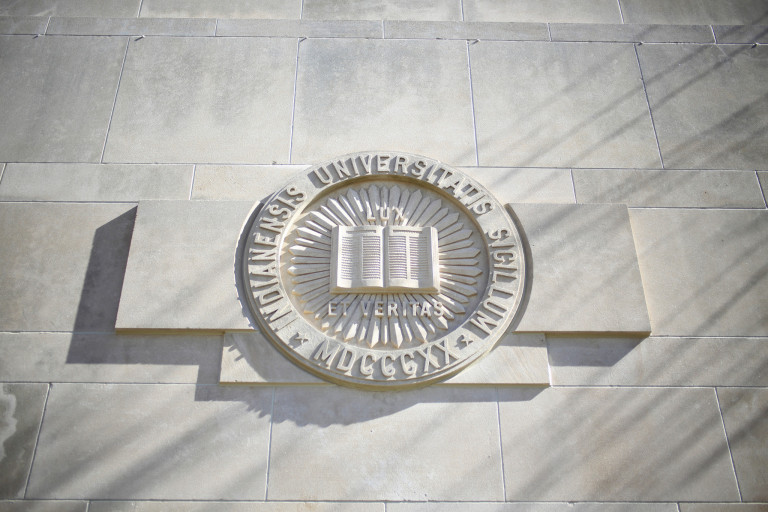 IU seal carved into a limestone building
