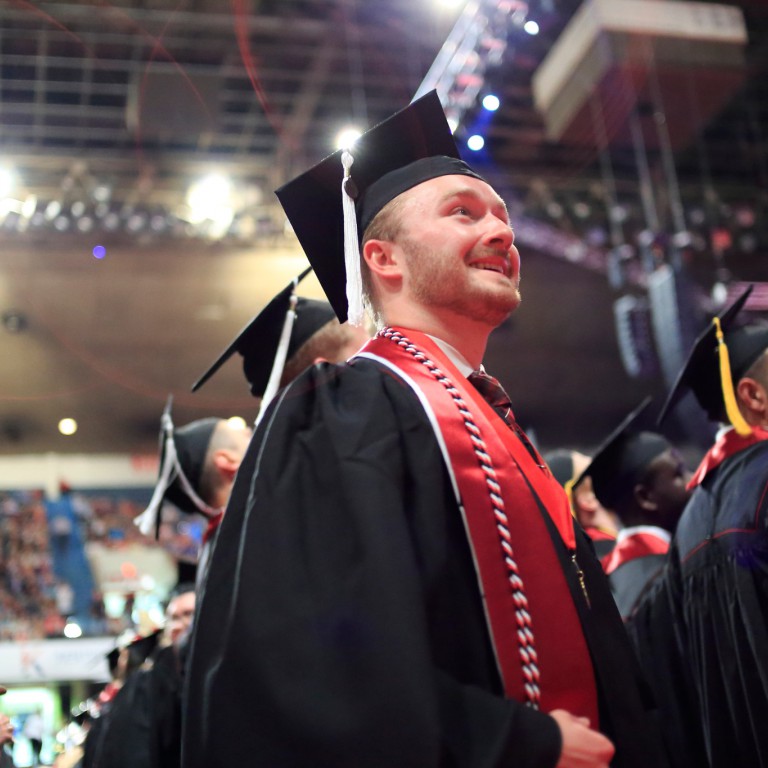 Graduate Roger Howard smiles as he participants in commencement.