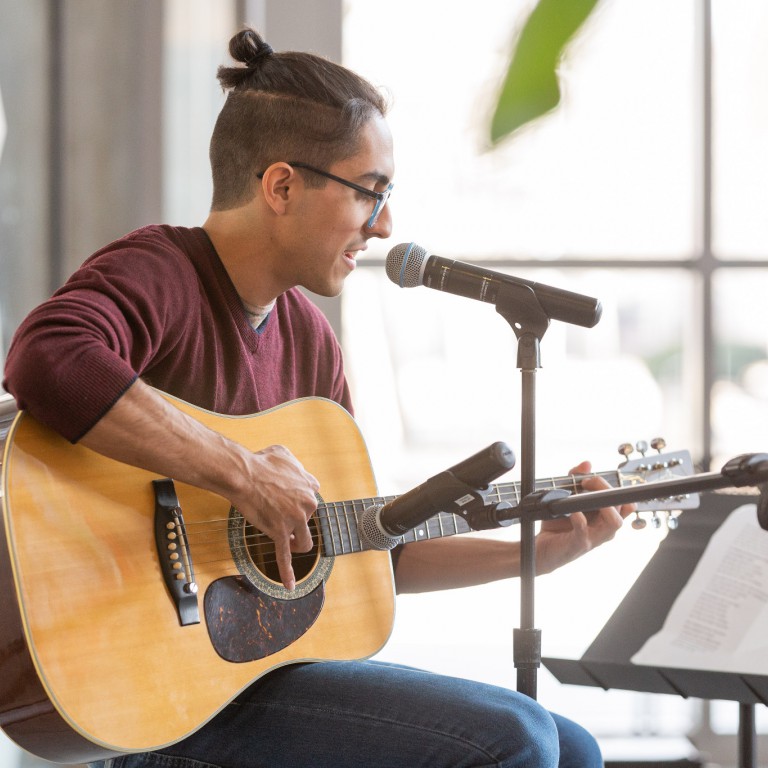 A student plays a guitar at the International Festival