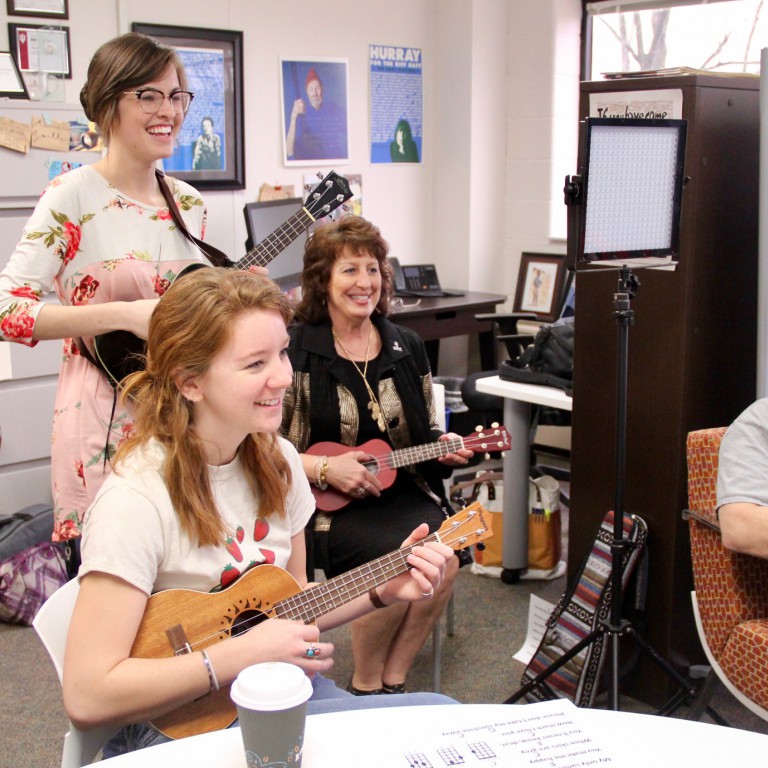 Ukulele Players play their ukuleles.