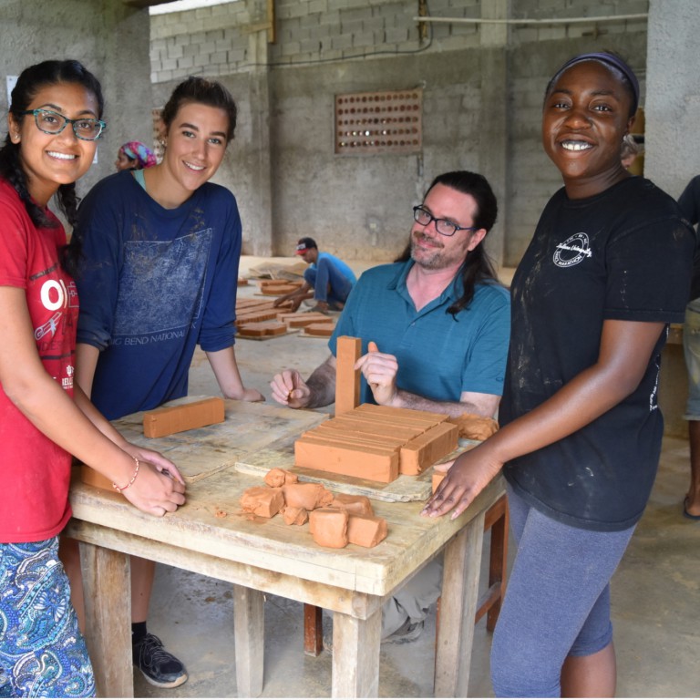 Amee Sangani, Meghan Moody, Bill Unrue and Fola Alade work in the water filter factory. 