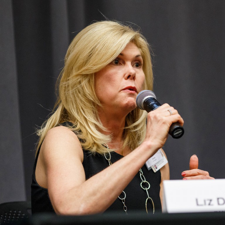 Panelist Jill Dunlap of IU Health speaks into a microphone to answer a question from the moderator.