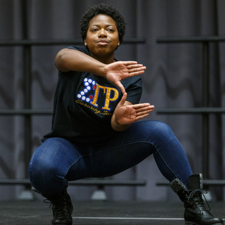 A member of Sigma Gamma Rho Sorority performs at the Yard Show, displaying her sorority's sign