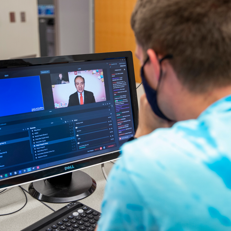 Student sitting in front of a computer screen.