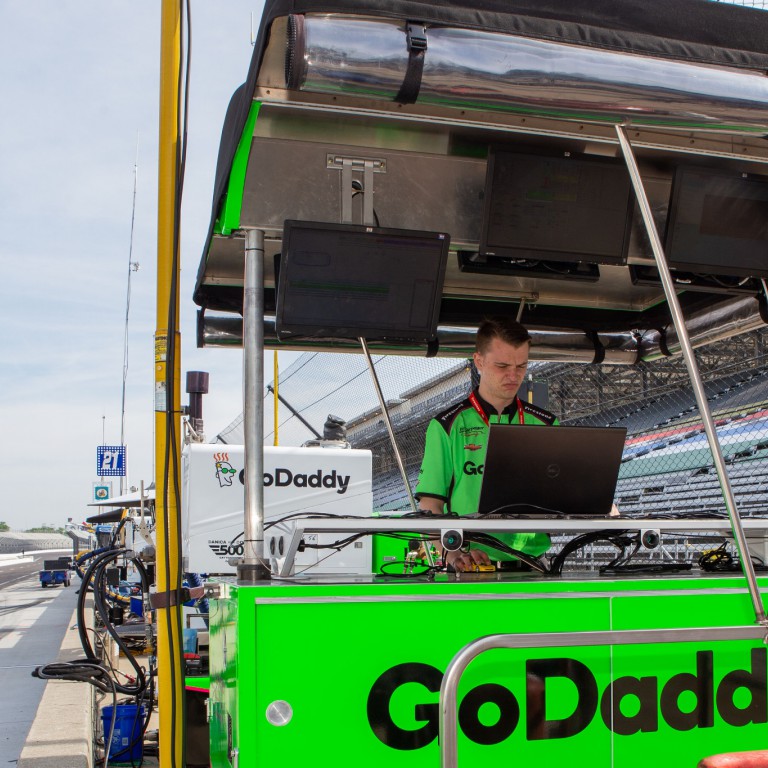 Darren Brubaker works atop an IndyCar pit box