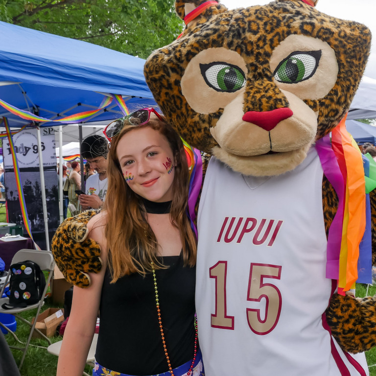 Jazzy the Jaguar poses with a female participant during the 2019 Indy Pride festival.