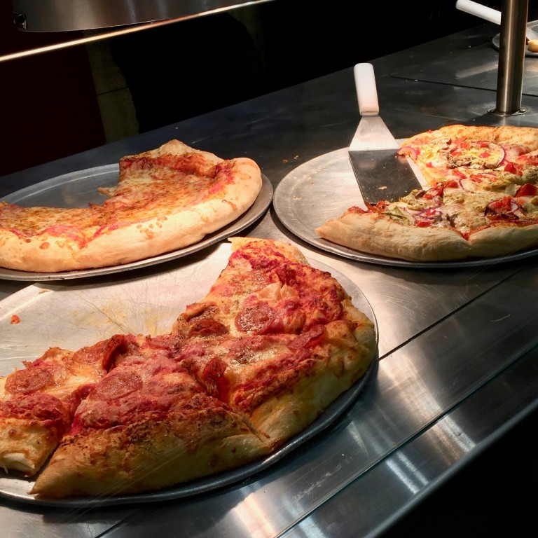 A variety of pizza by the slice options