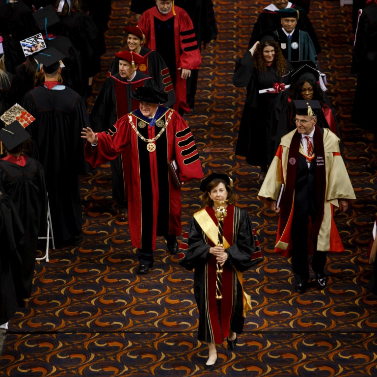 IU President Michael A. McRobbie walks with IU Northwest Chancellor William J. Lowe.