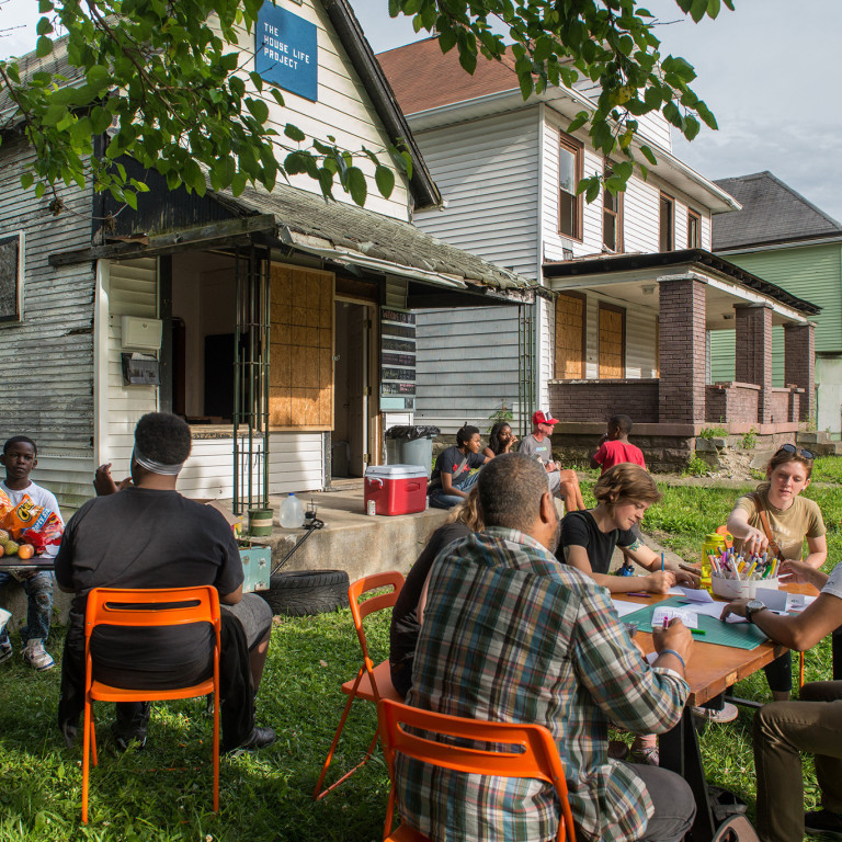 A porch party attracts dozens on a Tuesday evening.