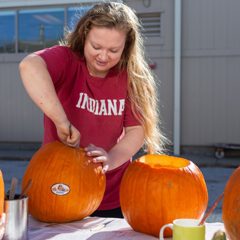 Shelby Lahne carves a pumpkin.