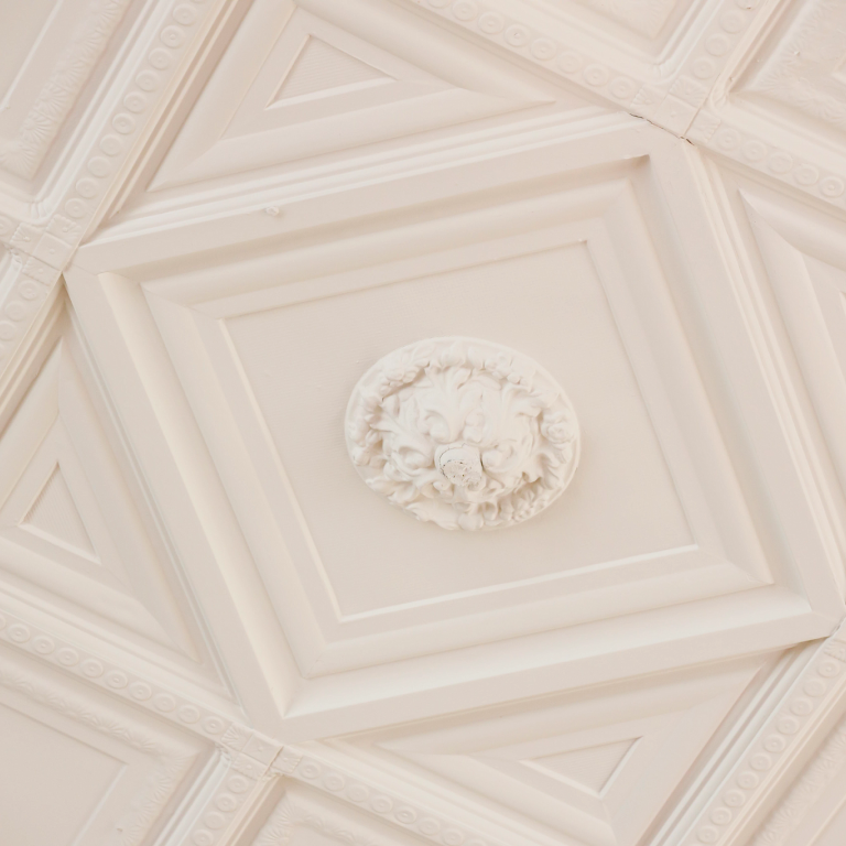 A painted tin ceiling adorns the former reading room