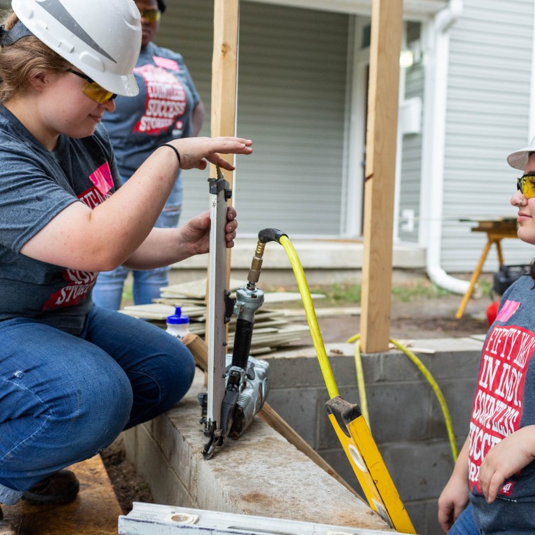 Students work on the 50th Anniversary Habitat build.