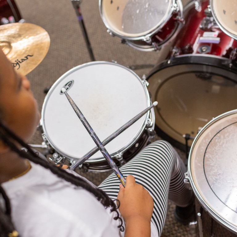 A Girls Rock Indianapolis camper gets ready on drums.