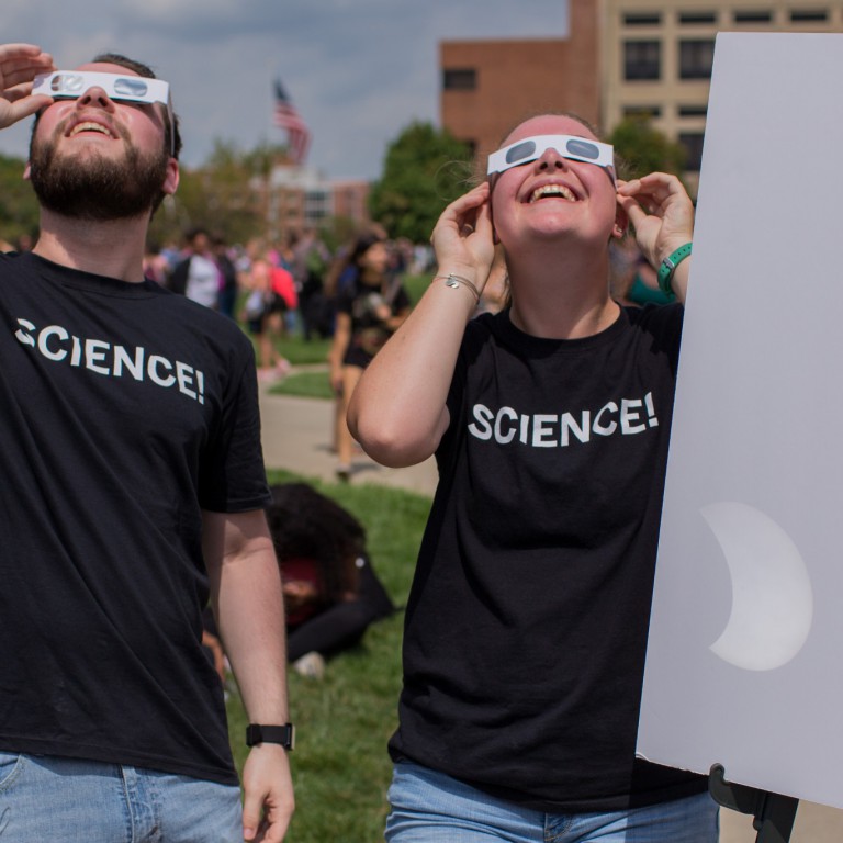 Science students watch a solar eclipse.