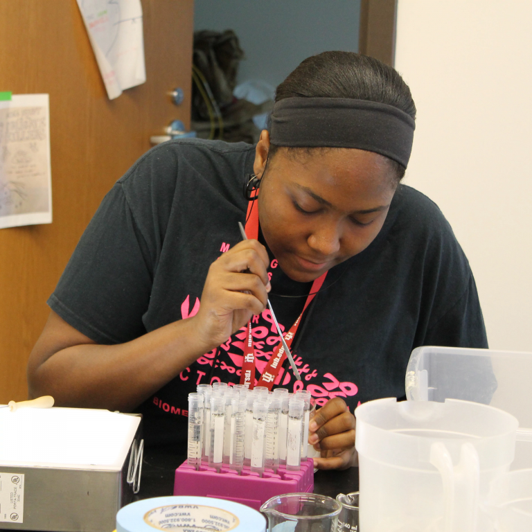 A student works with test tubes in a lab