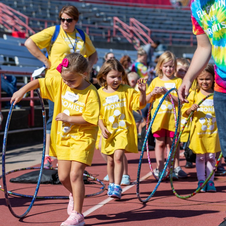 Kids play with hula hoops.