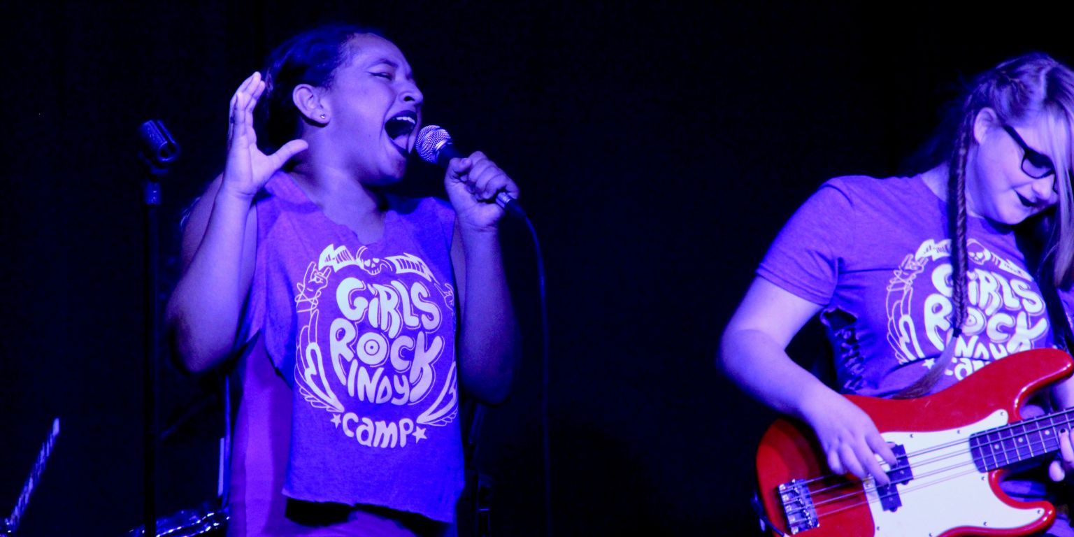 A girl sings on-stage.