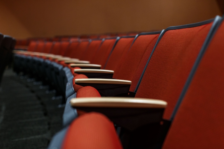 row of empty red chairs