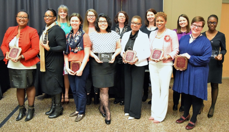 The honored women stand with their awards.