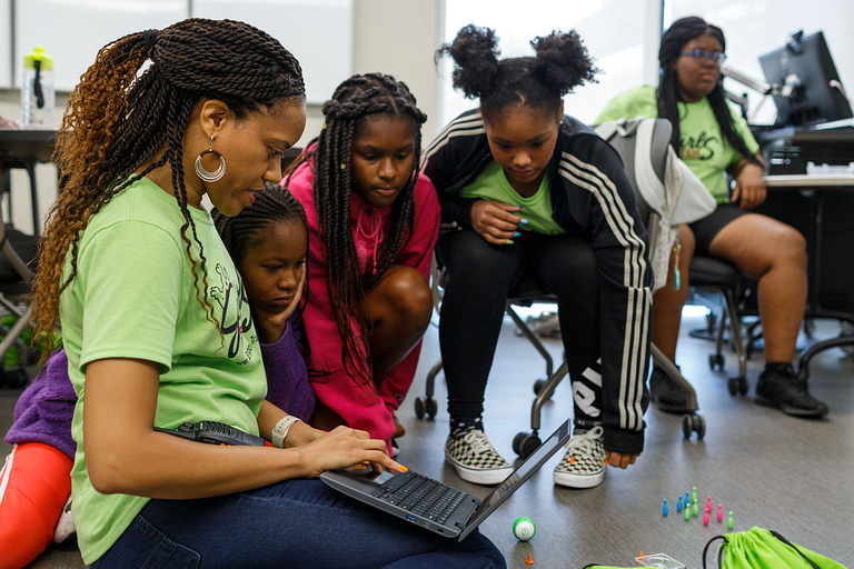 Crystal Morton, left, leads her campers through coding.
