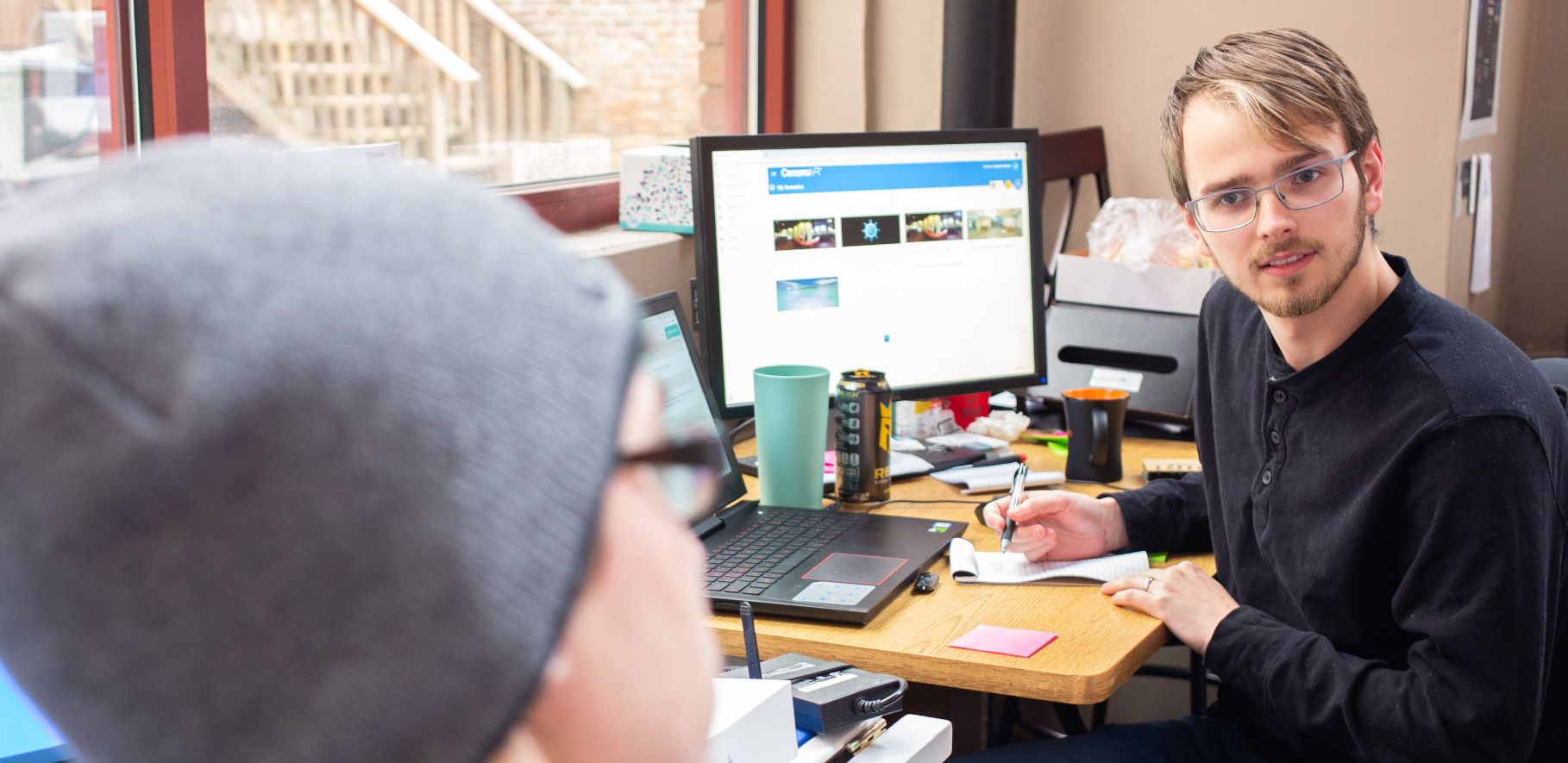 RegattaVR employees discuss a project.