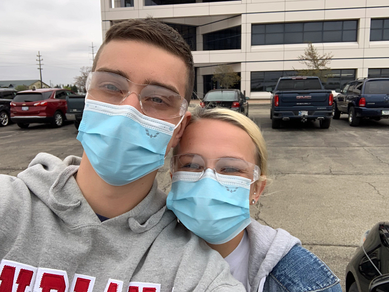 Alex Combs and Kate Wampler wear face masks at GM 