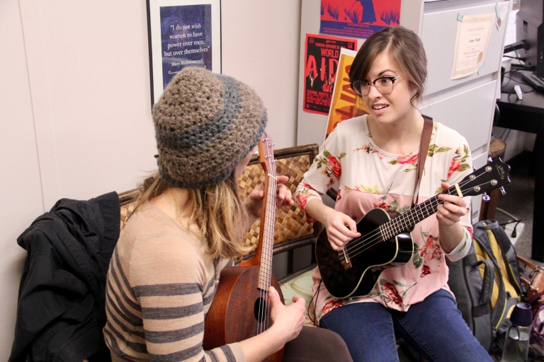 Stephanie Harman and Emily Edwards play their ukuleles.