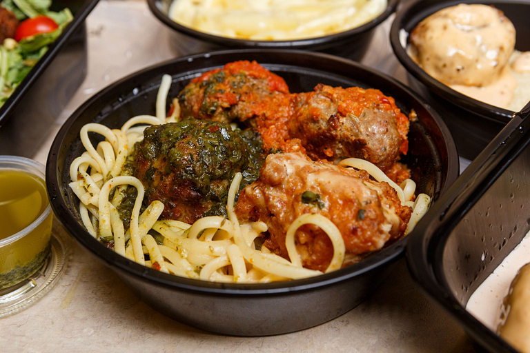 Four Mimi Blue meatballs smothered in four signature sauces, over a bed of linguine.