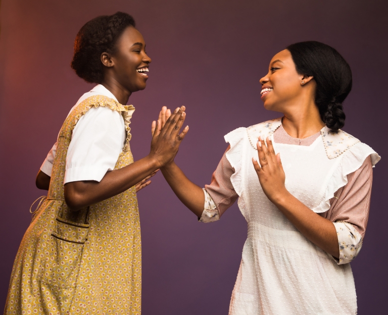 Two women touching hands