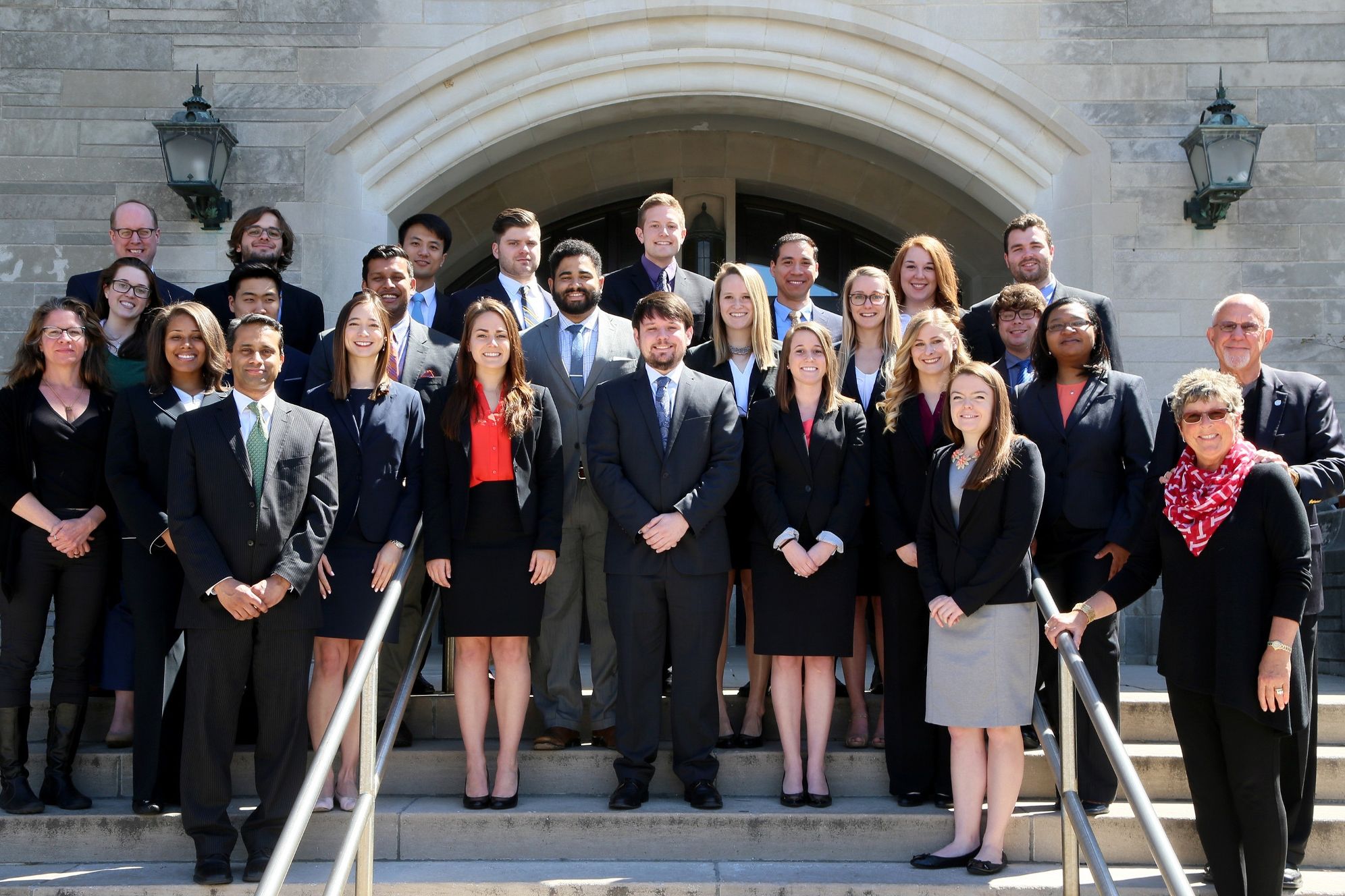 Stewart fellows pose together outside of a Maurer School of Law building.