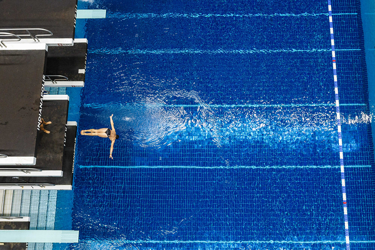 A person dives into the Natatorium pool