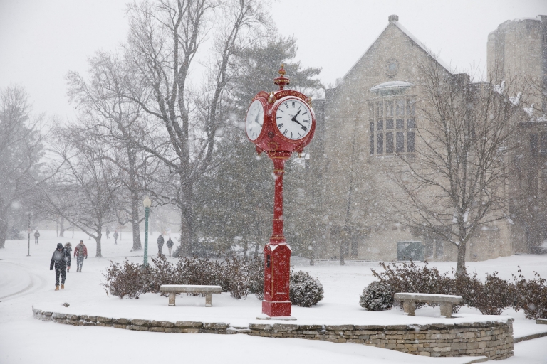 Red clock in snow