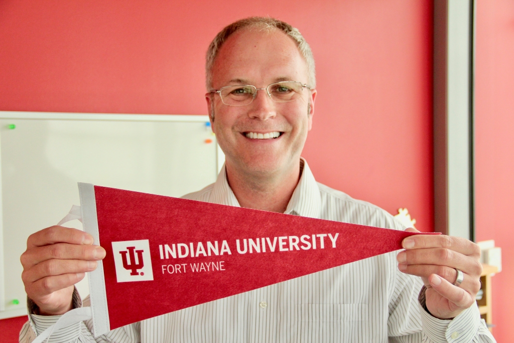 Boyd Bradshaw holds an IU Fort Wayne pennant.