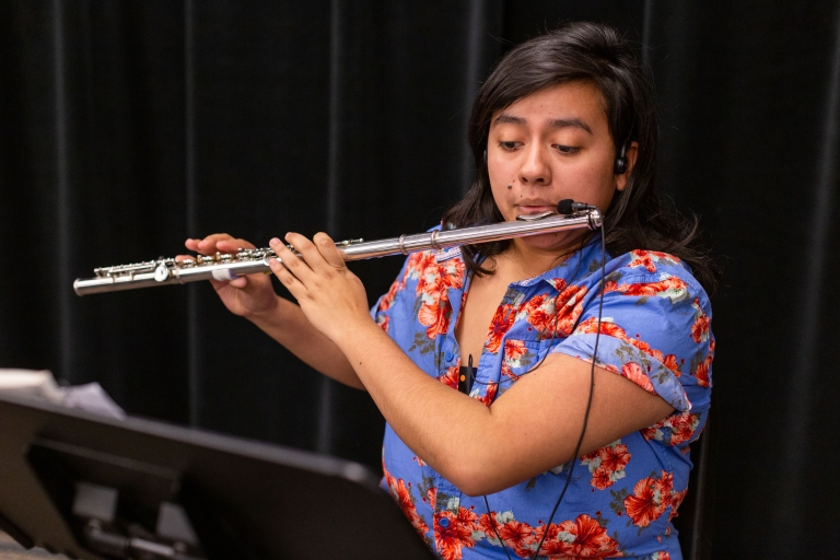 A student plays the flute.