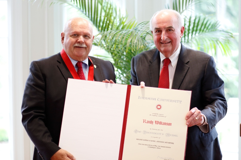 President Michael A. McRobbie presents Randy Williamson with the Presidential Medal of Excellence.
