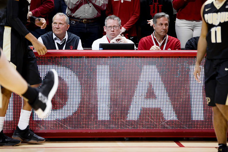 Steve Hitzeman, John Decker and Mick Renneisen sit at the scorekeepers' table at Assembly Hall.