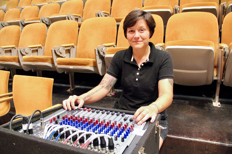 Sarah Masterson poses with a soundboard in the ICTC.